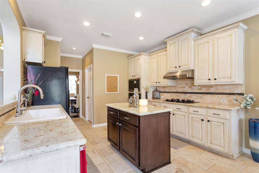 Stunning kitchen with elegant cabinetry, sleek countertops, and modern appliances. Perfect for culinary enthusiasts.
