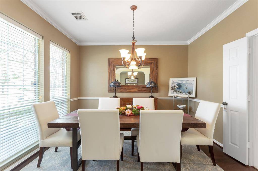 Elegant formal dining room with abundant natural light and charming front yard views.