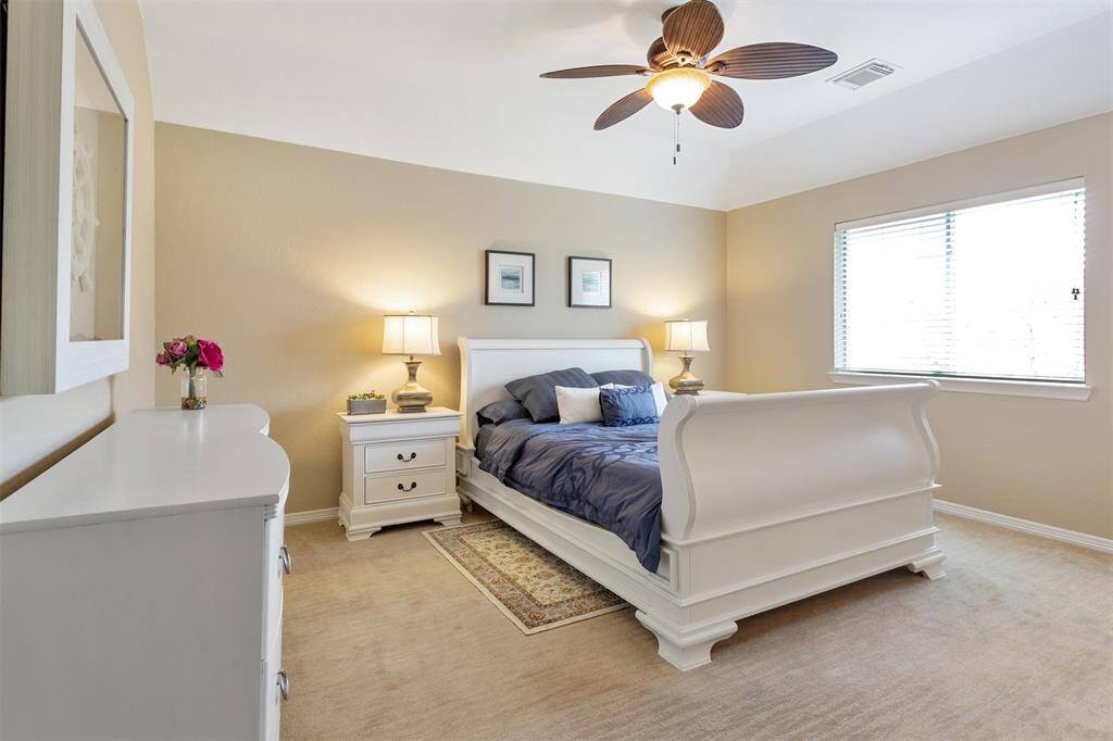 Cozy second bedroom with elegant furnishings and ample natural light.