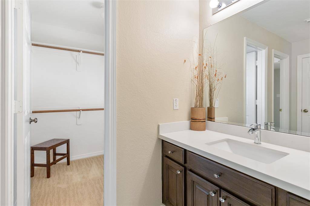 Elegant second-floor Jack and Jill bathroom featuring a modern vanity and ample natural light.