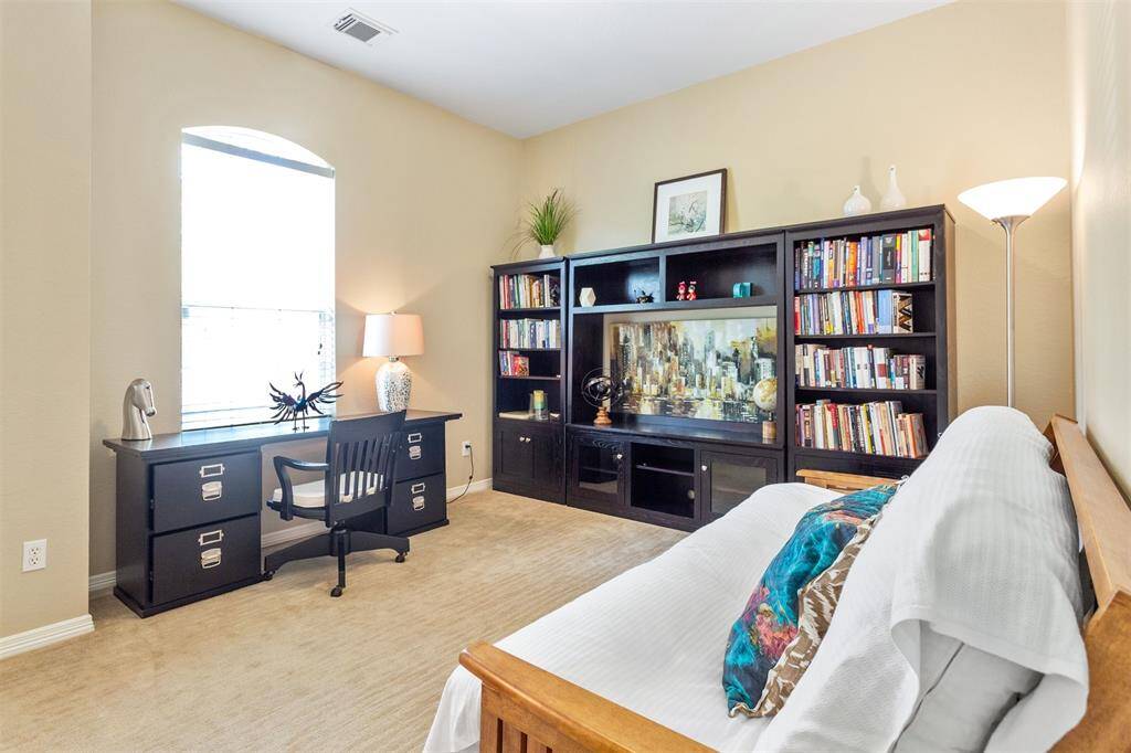 Versatile fourth bedroom currently designed as a functional home office.
