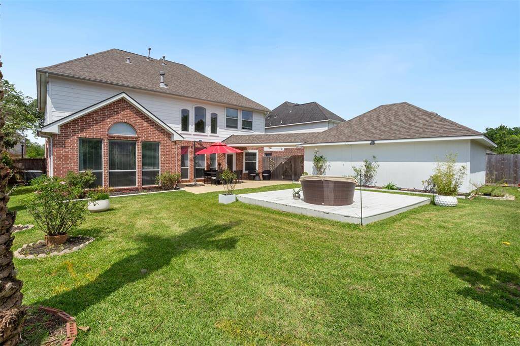 Expansive backyard with lush lawn, perfect for outdoor gatherings and relaxation.