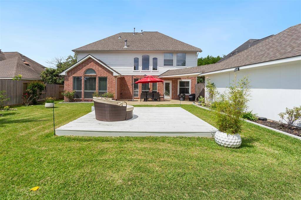 Expansive backyard with a spacious deck perfect for outdoor entertaining and relaxation.