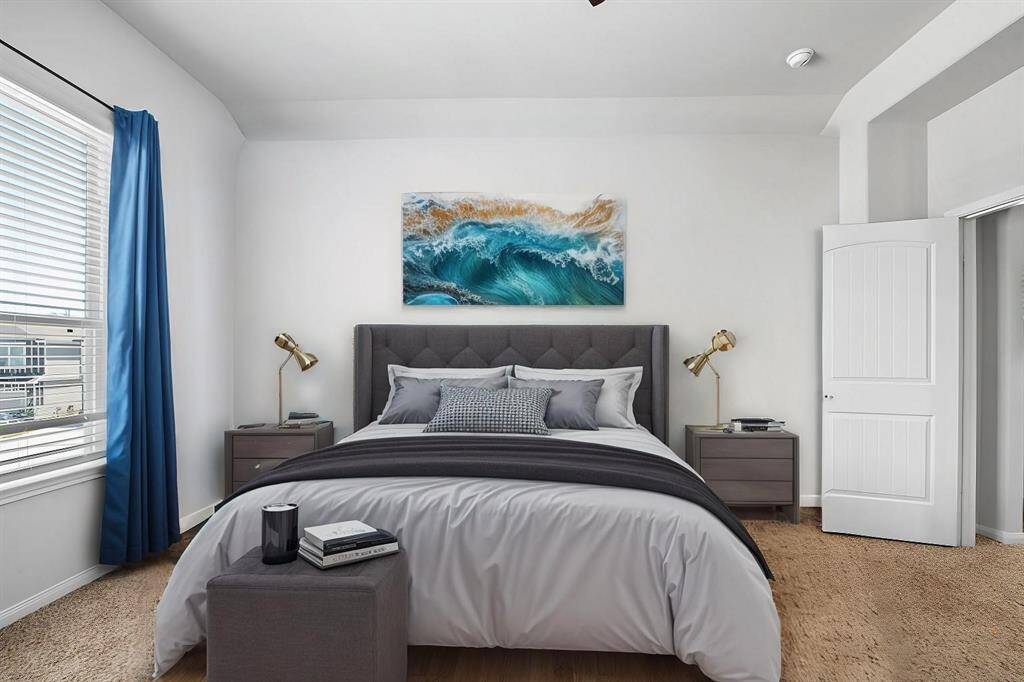 The light and airy primary suite offers a peaceful retreat with its spacious design and abundant natural light. A private ensuite bath adds convenience and luxury, creating the perfect space to unwind.