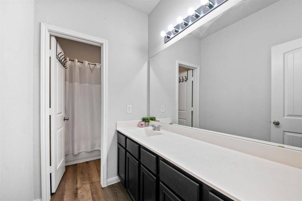 The secondary full bath offers a large single-sink vanity, providing ample counter space, along with a convenient separate tub and shower combo and facilities area adds privacy, both functional and spacious.