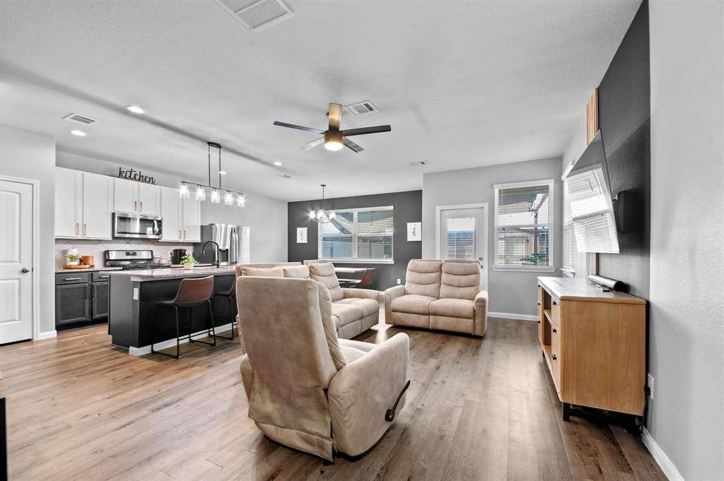 This light and bright open-concept seamlessly connects the family room, kitchen, and dining area, creating a perfect space for entertaining and everyday living. Featuring stylish LVT flooring.
