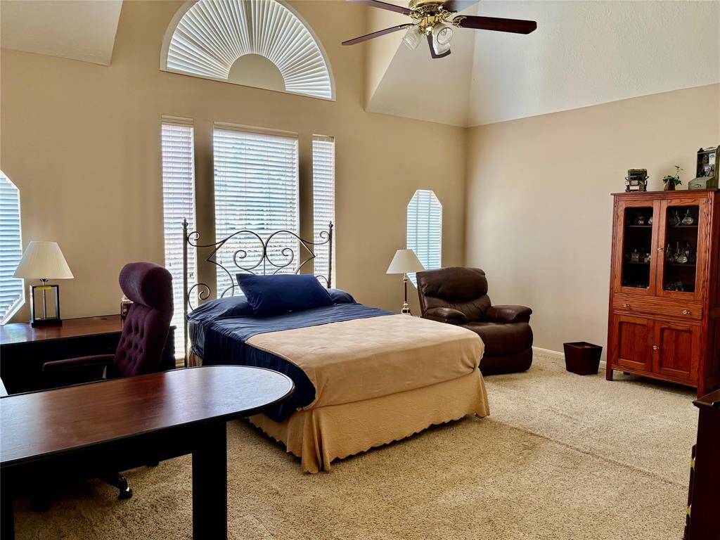 Experience luxury in the primary bedroom with its soaring ceilings and spaciousness.