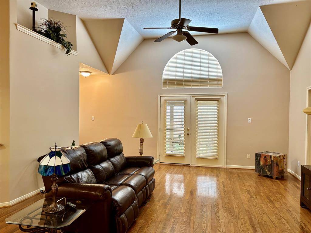 The double French doors open to a serene, shaded patio.