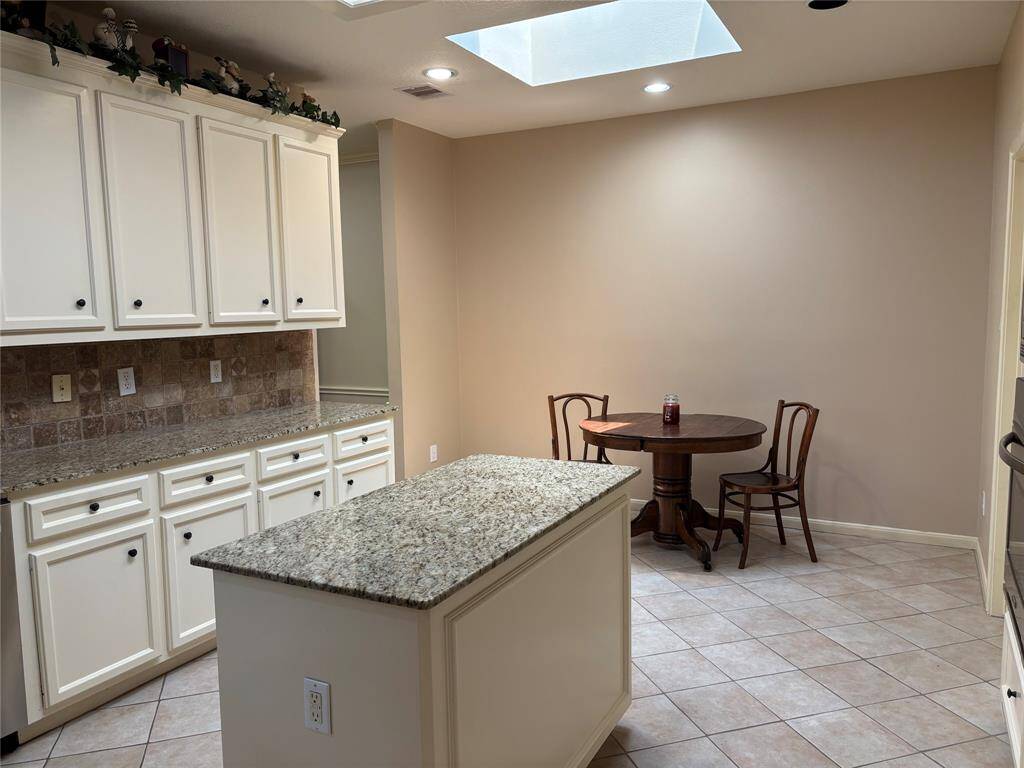 Experience seamless living with this kitchen's open flow into a bright breakfast area.