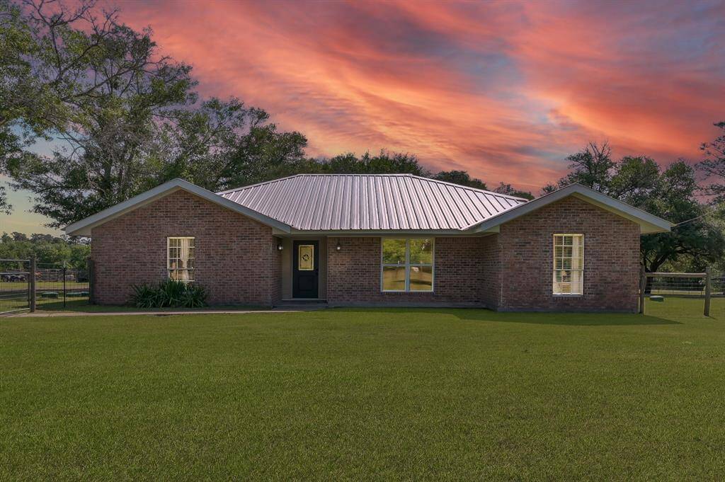 Welcome to your charming ranch home featuring a metal roof & nestled on 4 fenced acres!