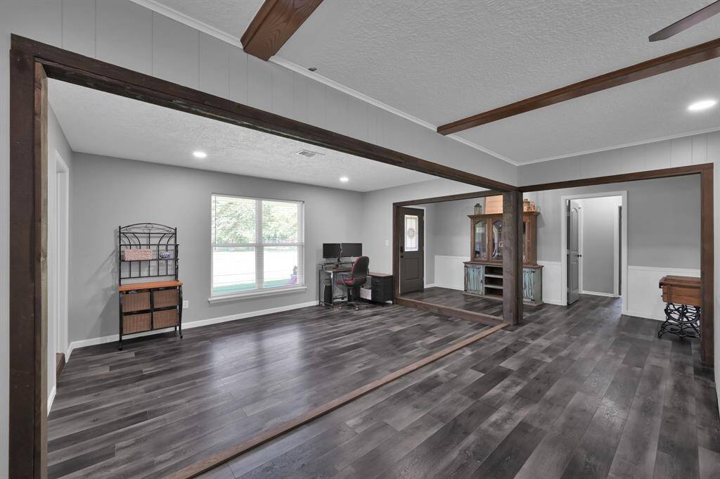 With exposed beams and a large window for natural light, this open layout is appreciated