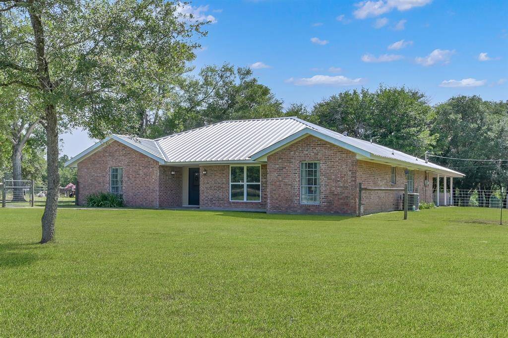 This charming brick home features a sleek metal roof & new fascia