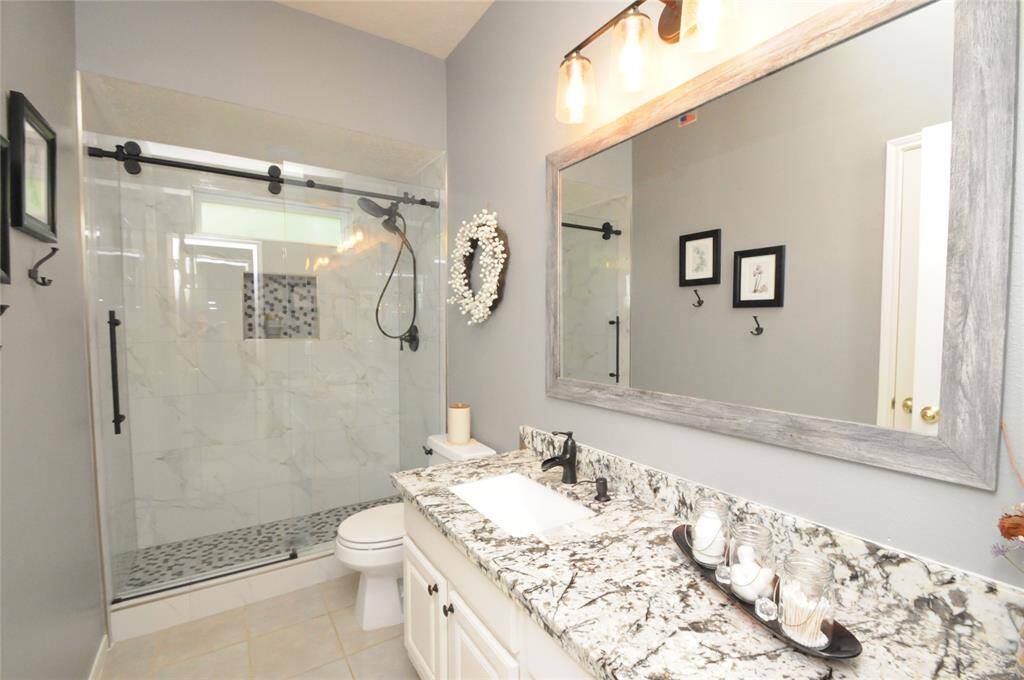 Fully renovated guest bath on the first floor features gorgeous granite counters, large walk-in shower and updated fixtures