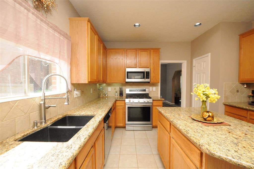 Kitchen also features a gas range, built in microwave and a large sink with window which allows natural light to pour in