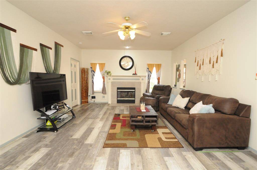 Family room with luxury vinyl plank floors and a cozy gas log fireplace