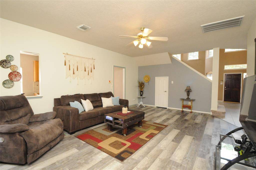 Small door leads to a storage closet under the stairs and opening leads to the kitchen