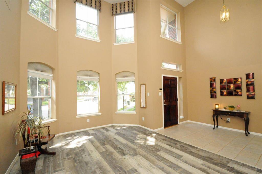 This room feels airy and spacious due to the abundant light from the multiple windows across the front of the home