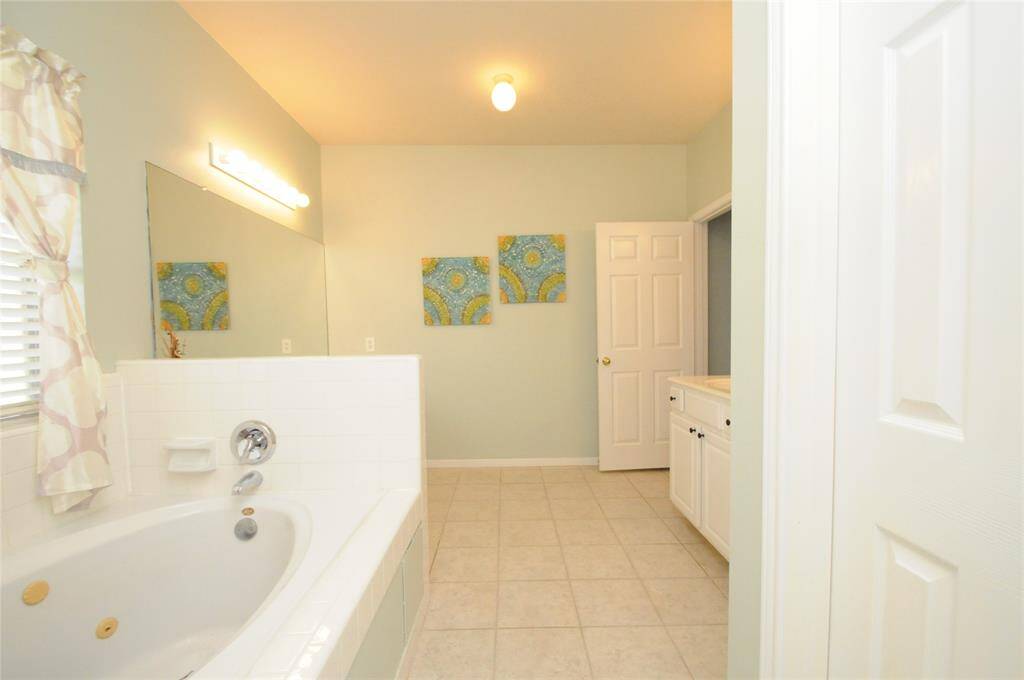 Jetted tub and separate shower and vanities offer plenty of space while getting ready in the morning