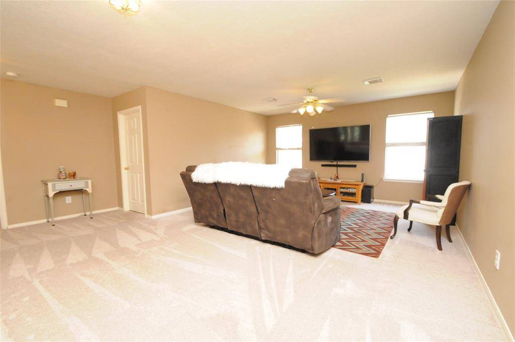 Upstairs gameroom is large enough for a pool table, media room, etc. (Mounted TV in this room stays with the home)