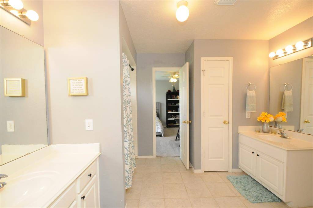 Dual vanities in this full bath upstairs make getting ready in the mornings a breeze
