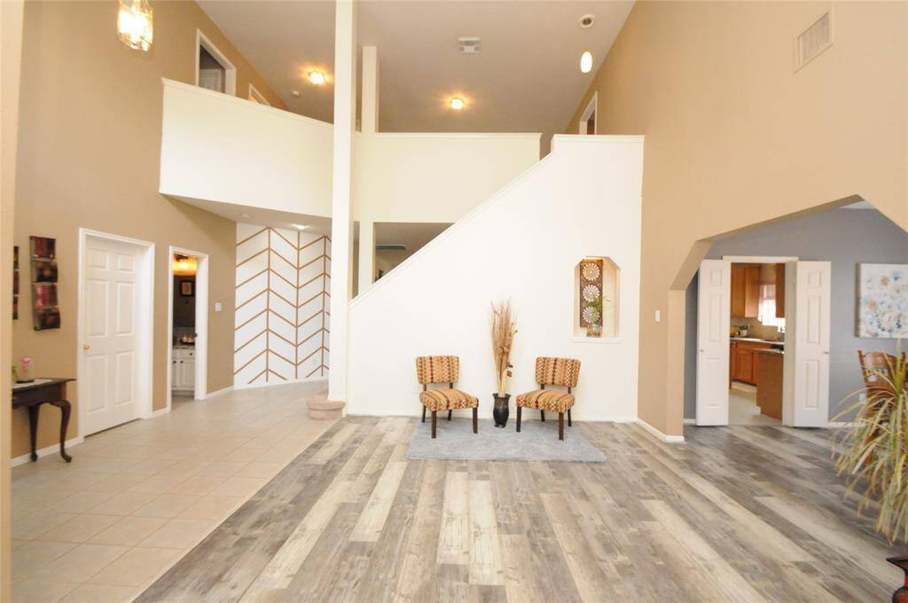 As you enter this stunning home you are greeted by soaring ceilings and open sitting area perfect for entertaining guests
