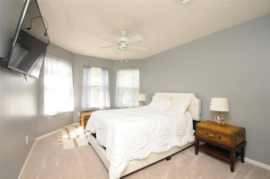 This room offers a ceiling fan and beautiful bay window