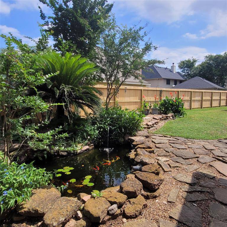 Notice the stone work around the pond and new fence