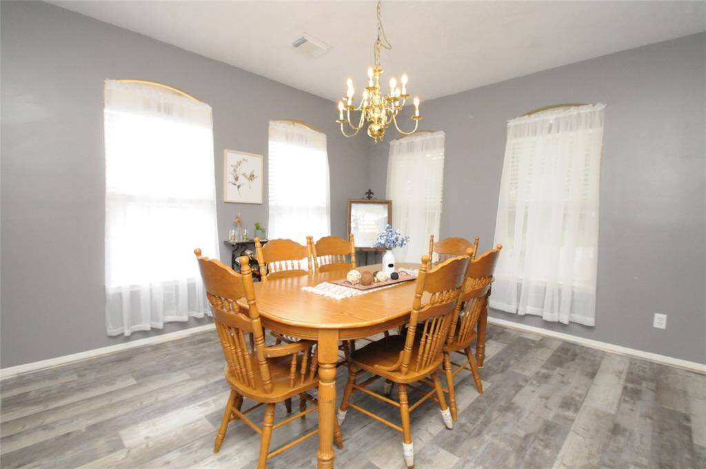 The formal dining boasts updated luxury vinyl plank floors which are both durable and easy to maintain