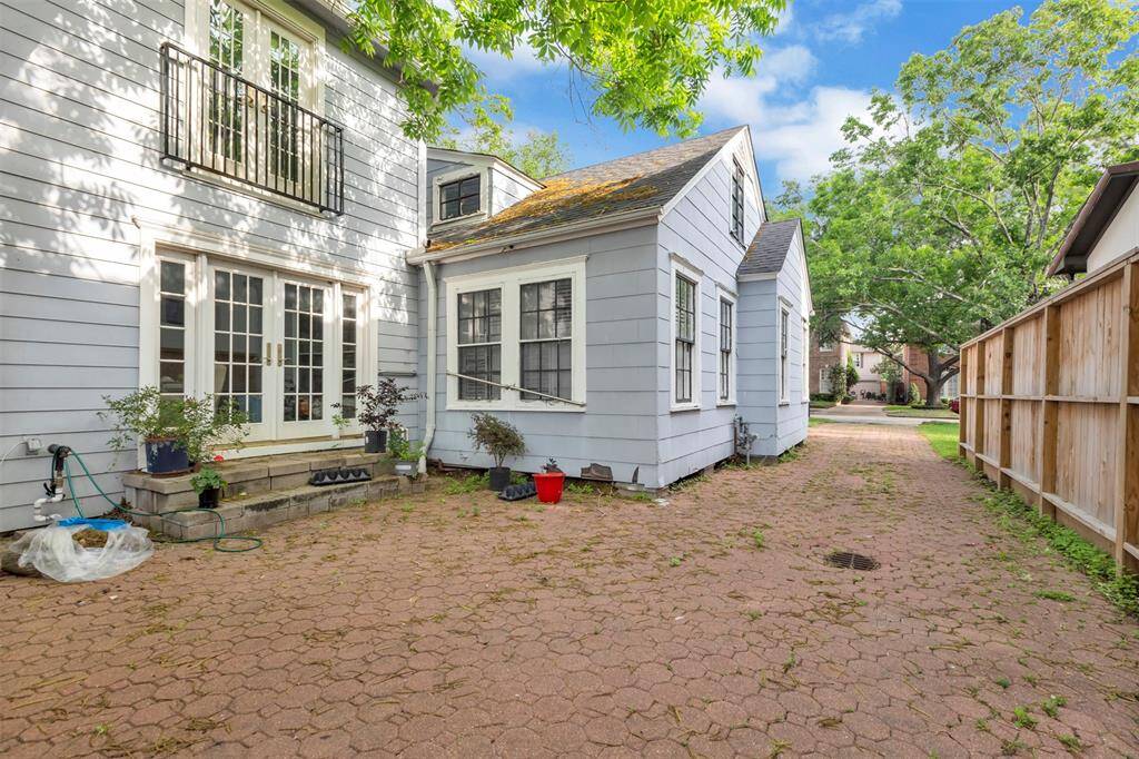 Beautiful wrap-around yard featuring patterned concrete, offering both style and low-maintenance outdoor space.