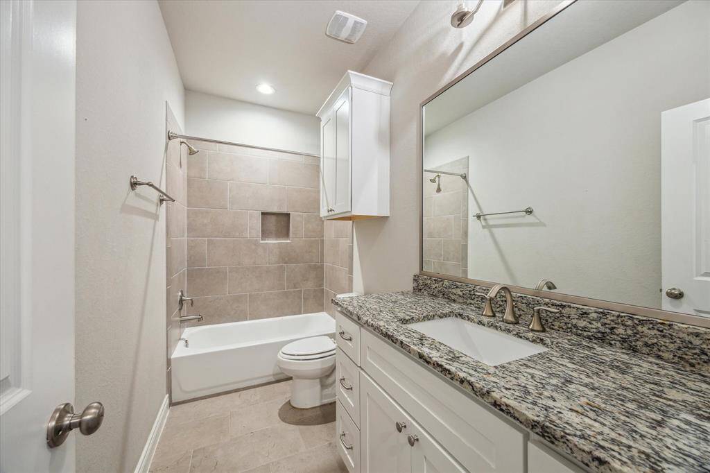 Modern secondary bathroom featuring a tub-shower combination for versatile convenience.