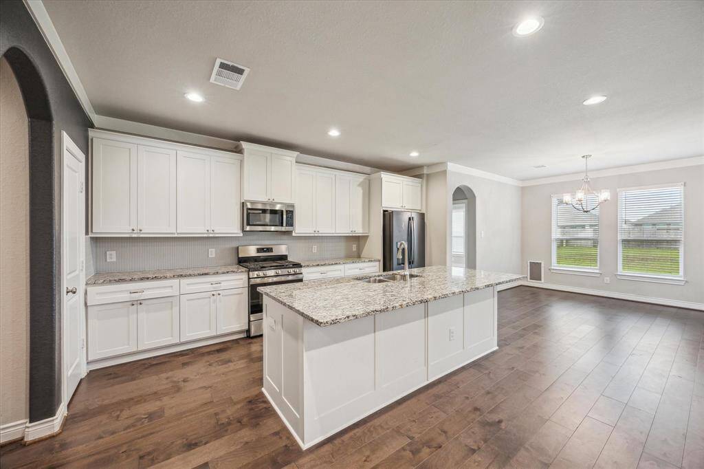 Spacious kitchen with a large island and abundant cabinet storage.
