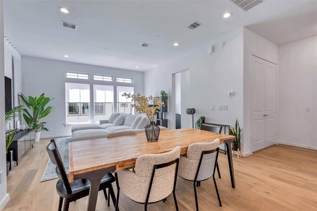 A bright and airy view of the dining area and living room, seamlessly flowing together.