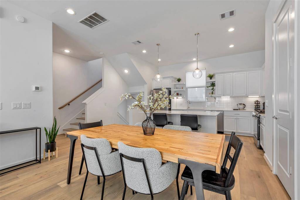 A closer look at the dining area and kitchen, with a more defined view of the staircases that lead both up to the second floor and down to the first.