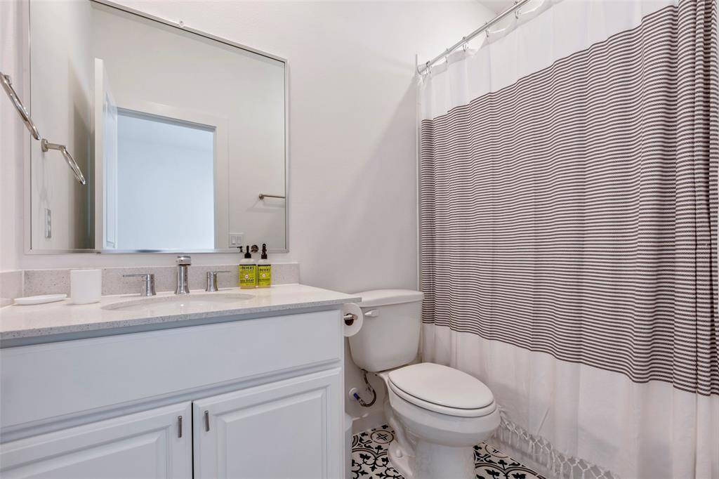 Inside the third-floor secondary bedroom is a private en-suite bath, complete with a convenient tub and shower combo.