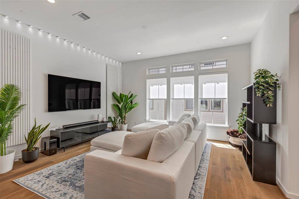 This gorgeous living room is filled with natural light, stylish touches, and the perfect space to relax or entertain.