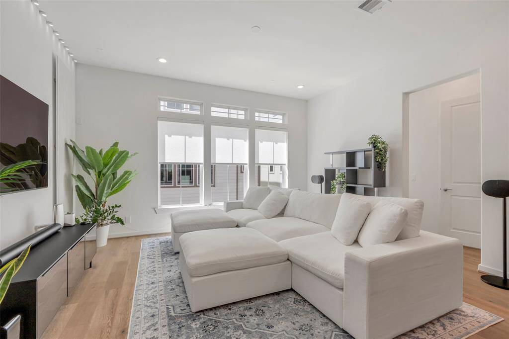 Just off the living room, a discreet door leads to a convenient half bath and a bonus space.