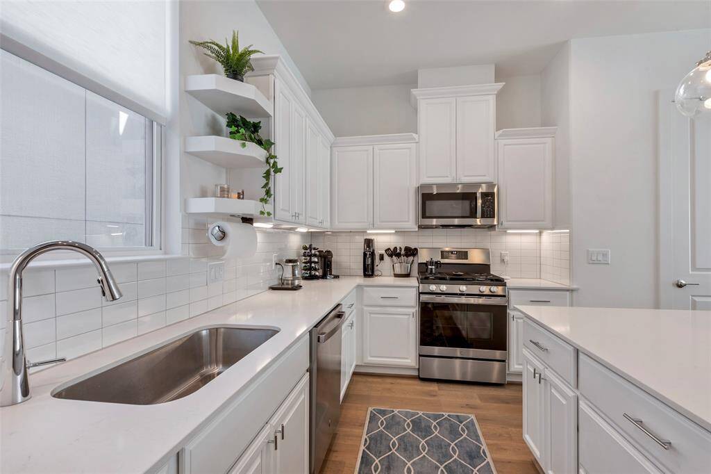 It boasts beautiful quartz countertops and an abundance of cabinetry, providing both style and ample storage space.