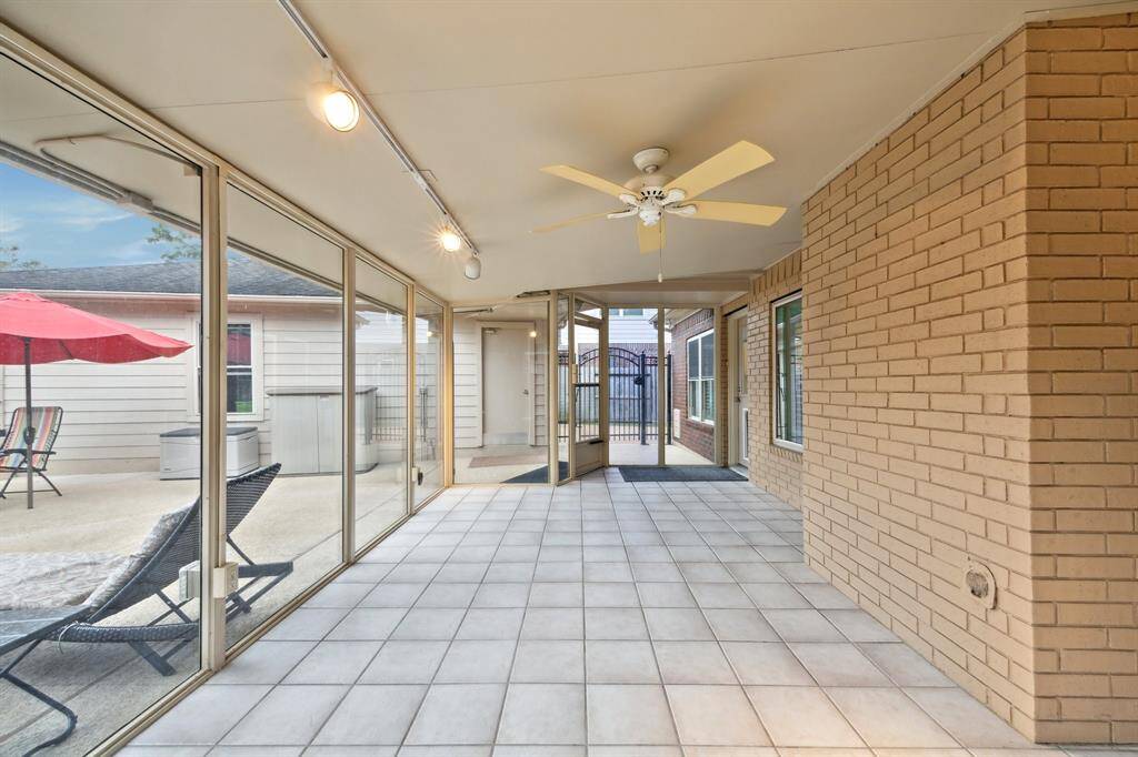 AIR CONDITIONED SUN ROOM OFFERS A CEILING FAN AND CERAMIC TILE FOR EASY CLEANING