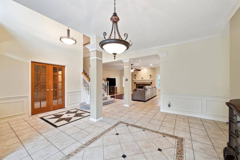 VIEWS FROM THE DINING ROOM AND BEAUTIFUL FLOORING DETAIL. THE STUDY IS LOCATED AT ENTRY TO THE LEFT FEATURING DOUBLE GLASS PANE DOORS