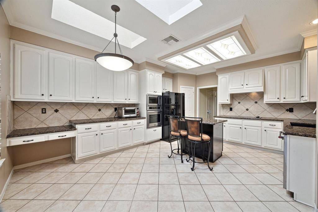 THE BUILT-IN DESK MAKES A GREAT COMMUNITY OFFICE AREA AND BUFFET FOR FOOD PREP AND DISPLAYS