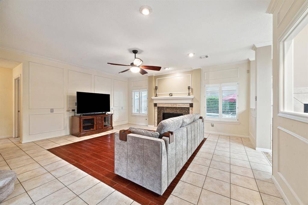 CERAMIC TILE THROUGHOUT DOWNSTAIRS AND DECORATIVE BORDERS TRIM OUT THE ELEGANT WALLS