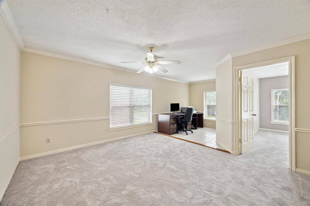 GAME ROOM UP FEATURES CROWN MOLDING, AN OFFICE W/ BUILT -IN BOOK SHELVES, OR A PLAY AREA FOR KIDS WITH CERAMIC TILE, AND WINDOW SHINES THROUGH FROM THE FRONT YARD. THE 4TH BEDROOM SITS OFF OF THE GAME ROOM