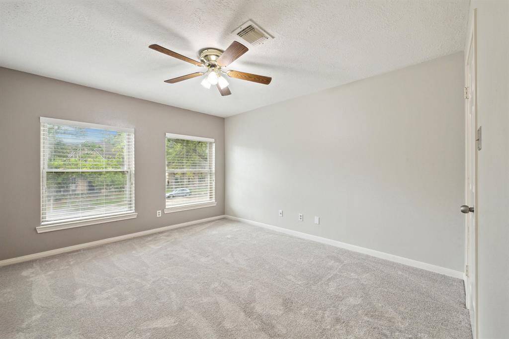 THE 4TH BEDROOM SITS OFF OF THE GAME ROOM, LOOKS OUT TO THE FRONT YARD AND HAS A WALK-IN CLOSET AND CEILING FAN AND NEW CARPET!