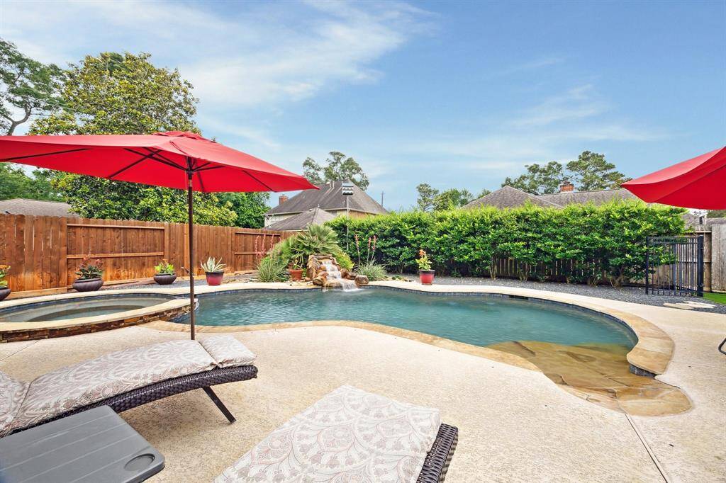 GRASSY AREA TO THE RIGHT BACK OF GARAGE FOR PETS INCLUDES AN IRON FENCED AREA