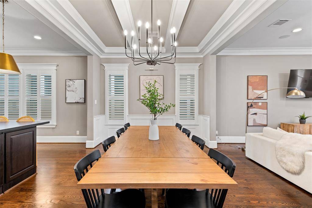 Framed by coffered ceilings and elegant wall paneling, the dining area offers a refined setting for both everyday meals and special occasions.