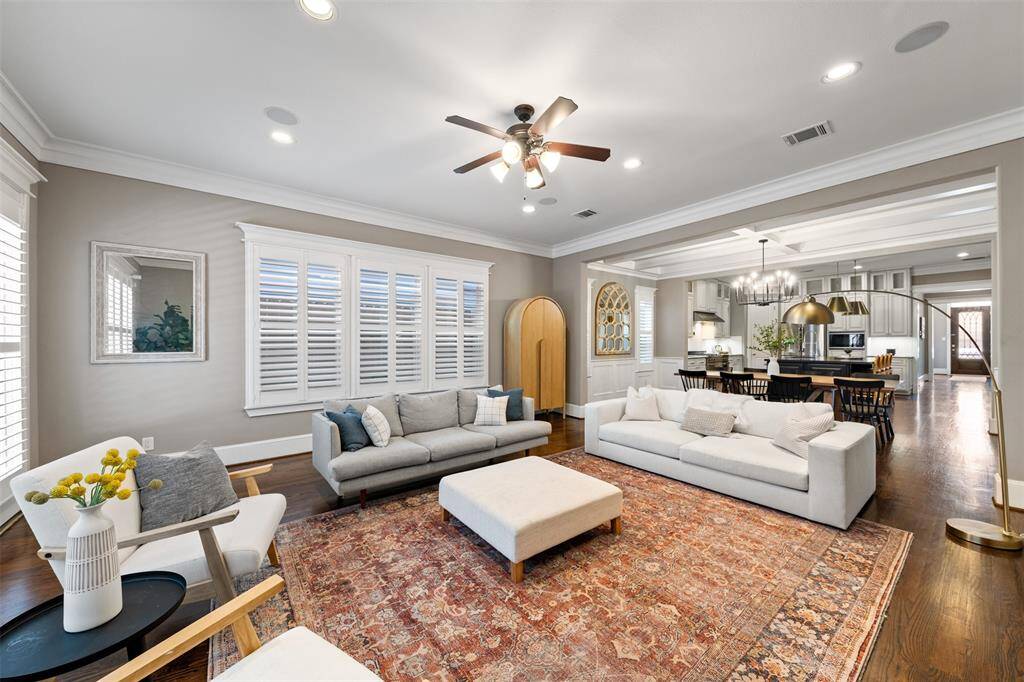 Enjoy elevated comfort in the open-concept living area, where high ceilings, crown molding, and wide-plank hardwoods create a warm, welcoming atmosphere.