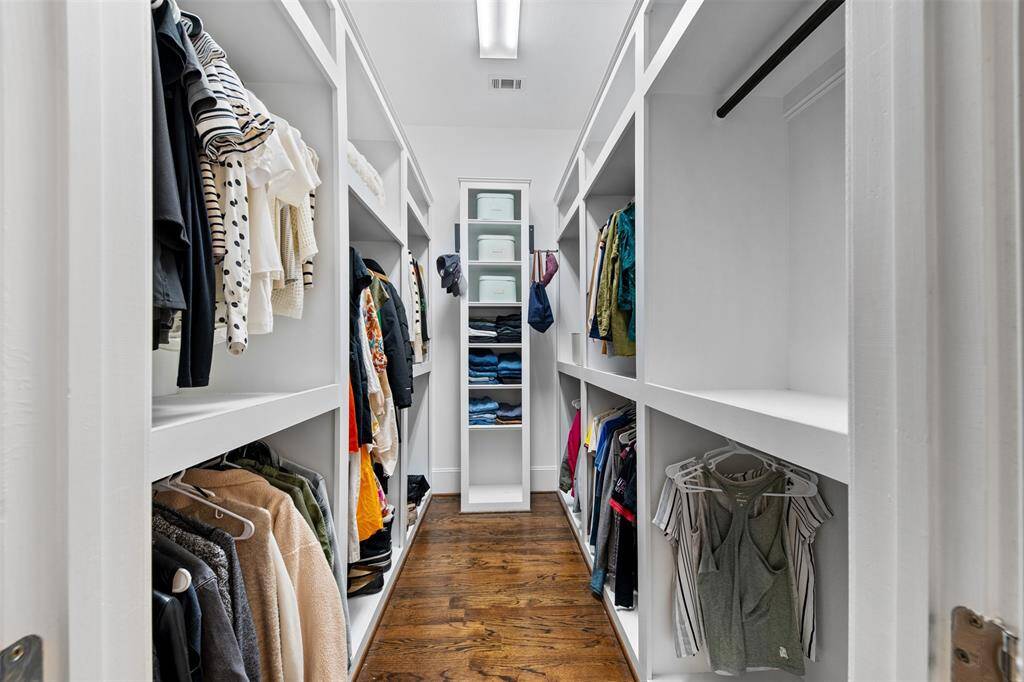 The expansive walk-in closet offers ample storage space with custom shelving and plenty of room for your entire wardrobe.