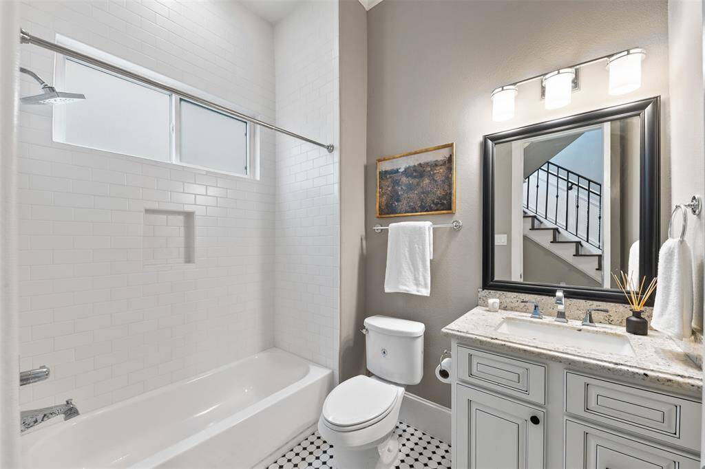 A beautifully appointed full bath on the first floor, ideally located next to the study—perfect for guests or everyday convenience.