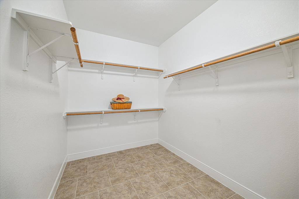 Spacious primary closet with ample storage space.