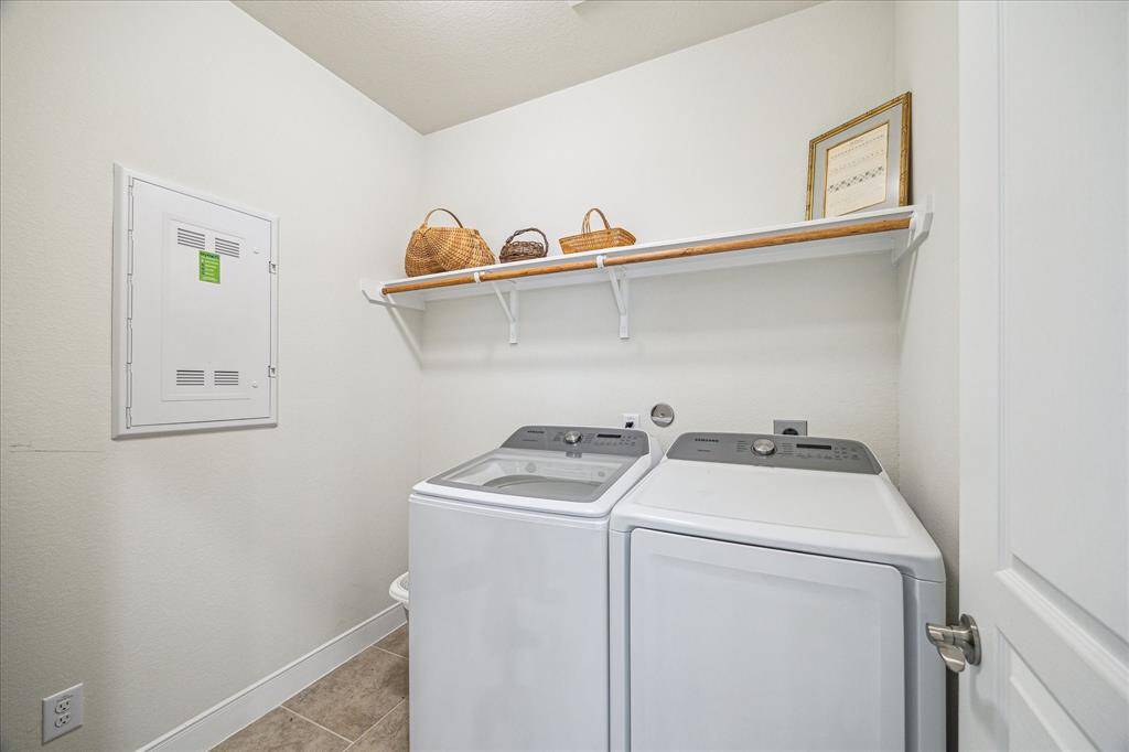 Spacious laundry room with modern appliances and smart home wiring for convenience.